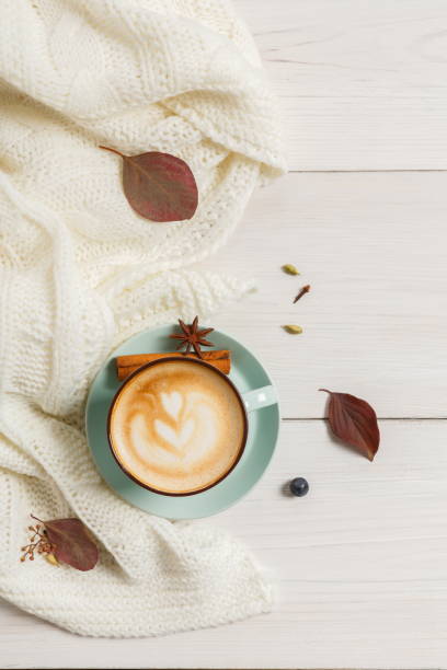 istock Autumn cappuccino coffee cup on white wood background 841195236