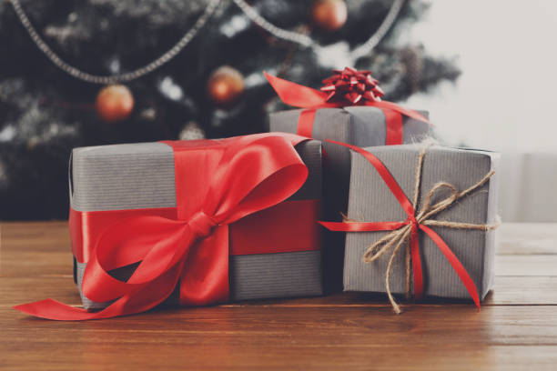 istock Christmas presents on decorated tree background, holiday concept 841199520