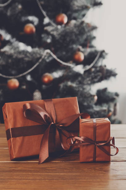 istock Christmas presents on decorated tree background, holiday concept 841199618
