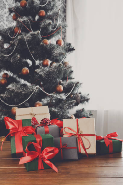 istock Christmas presents on decorated tree background, holiday concept 841199680