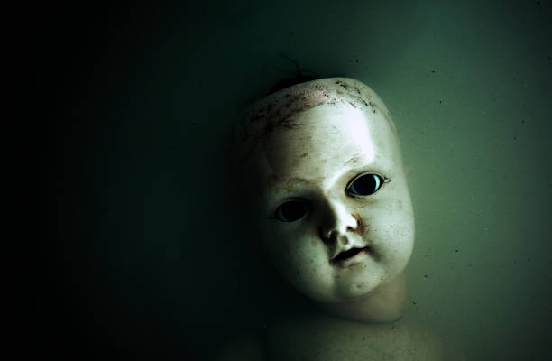 istock Creepy doll face in dark dirty water 841200612
