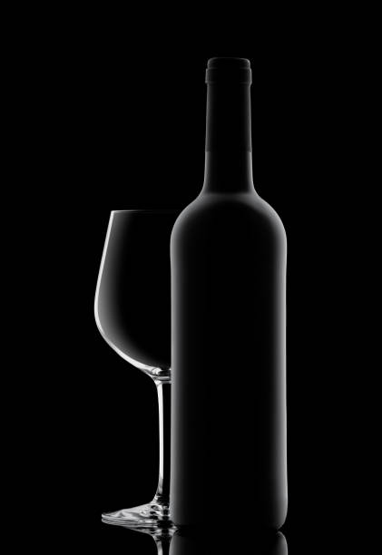 Silhouette of a bottle with wine on a black background stock photo
