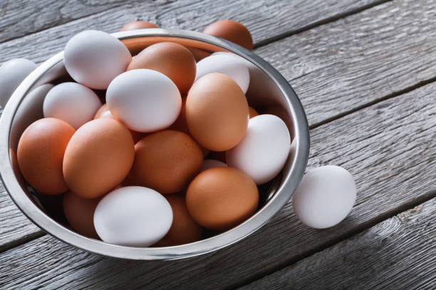 istock Fresh brown eggs in bowl on wood background 841201010