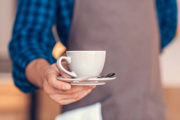 istock barista holding cup of coffee 841203614