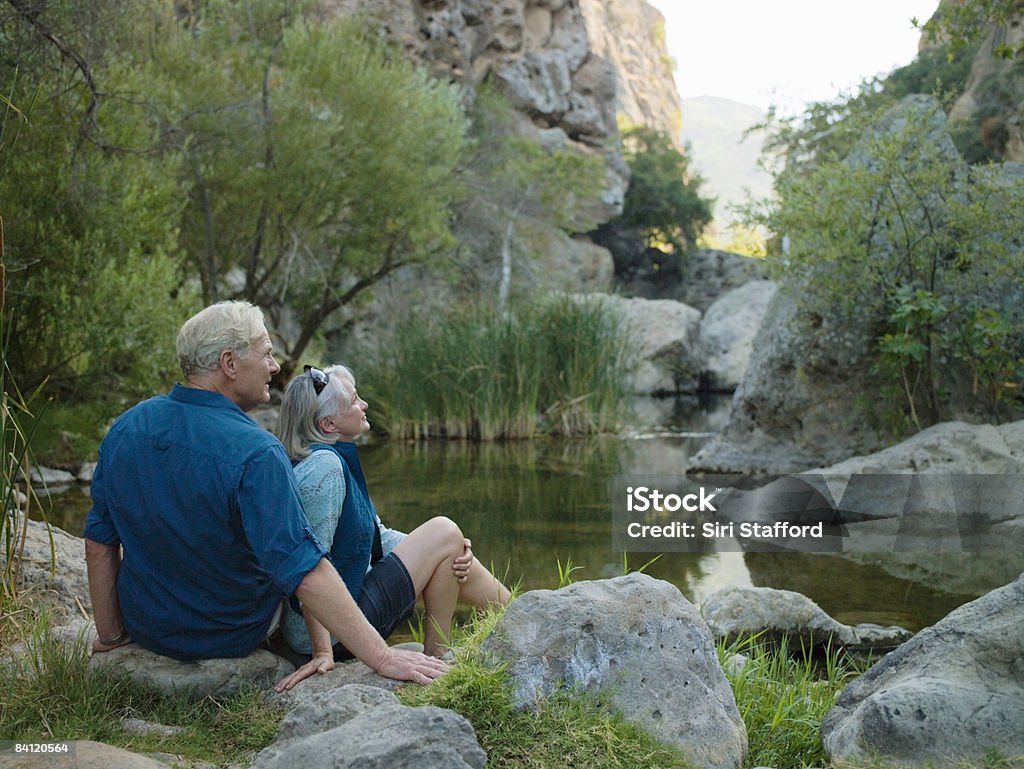 Mature couple sitting next to a canyon  Sitting Stock Photo