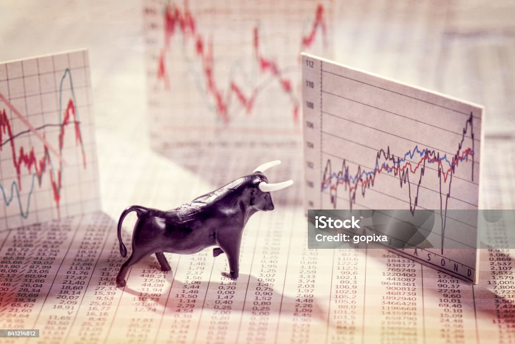 Rising prices on the stock exchange Figure of a Bull with price tables and charts Bull Market Stock Photo