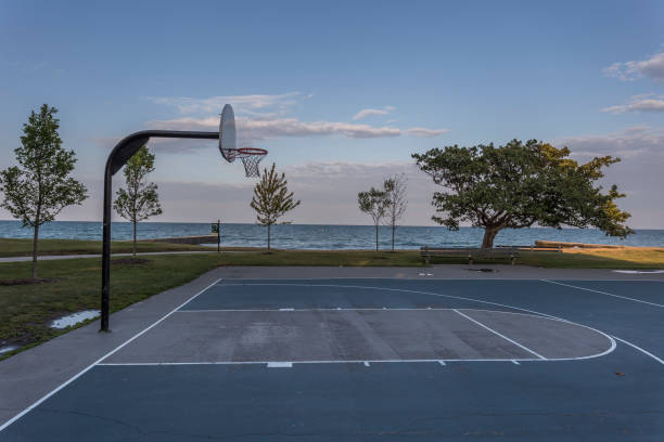 Basketball court with lake and sky Basketball court with lake and sky in the background asphalt basketball court stock pictures, royalty-free photos & images