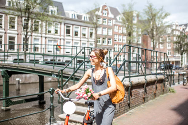 istock Woman with bicycle in Amsterdam city 841217728