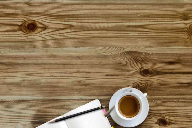istock Mock up : Work space desk table with blank notebook, pencil and coffee cup on wood. 841218110