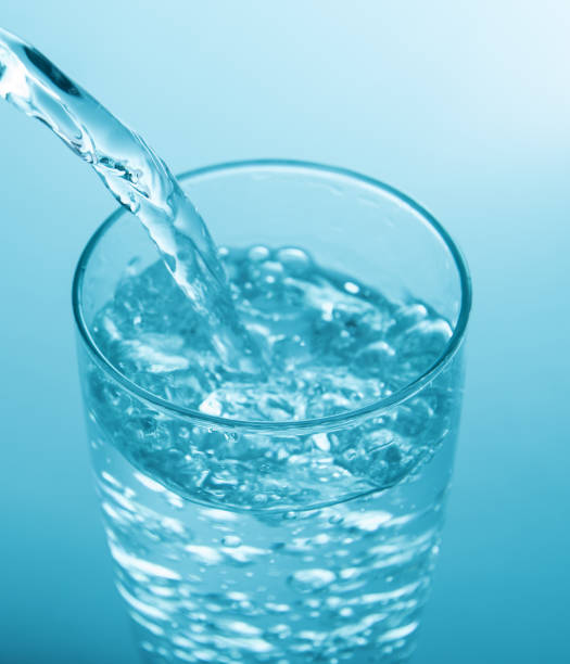 istock pouring water into glass 841218578