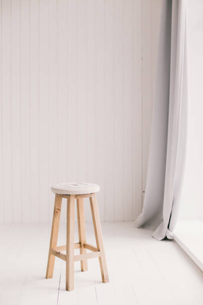 istock White and minimalistic: empty chair and curtain 841219336
