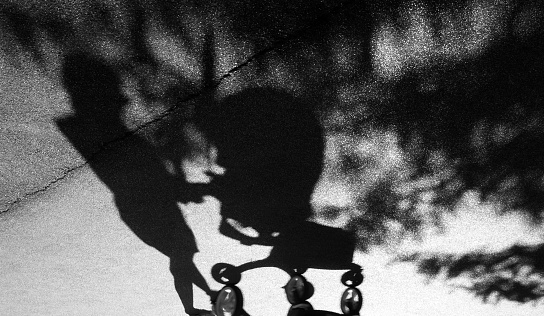 Shadow of a woman pushing a baby trolley