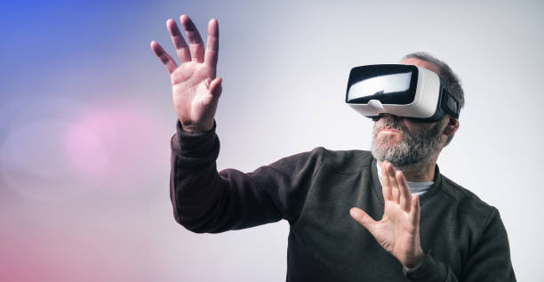 istock Mature business man wearing virtual reality goggles / VR Glasses to work with in modern office 841222014