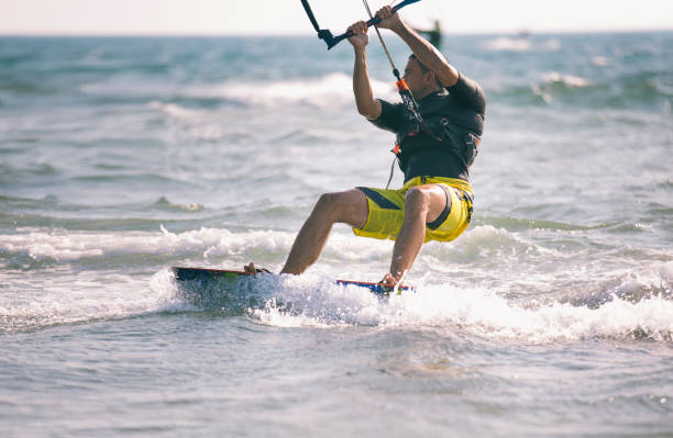 istock Man kiteboarding on choppy waves 841222382