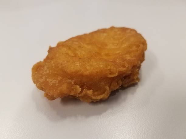 istock a chicken nugget with a bite taken out of it 841222572
