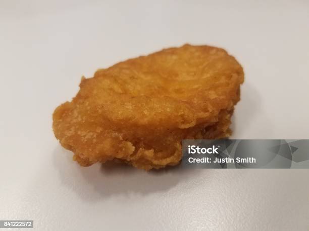 A Chicken Nugget With A Bite Taken Out Of It Stock Photo - Download Image Now - Animal, Biting, Chewed