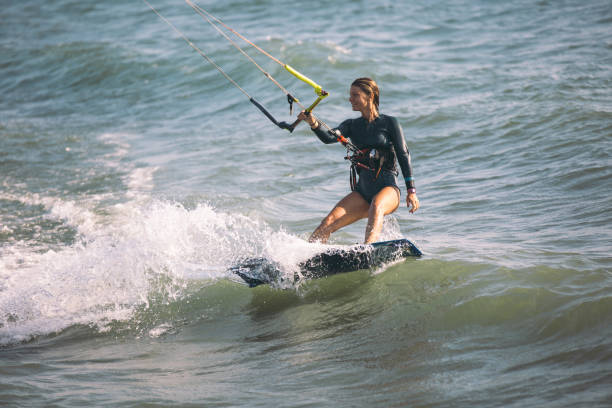 istock Kite surfing girl riding waves 841225818