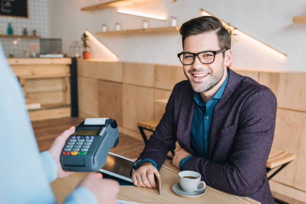 istock smiling businessman in cafe 841226116