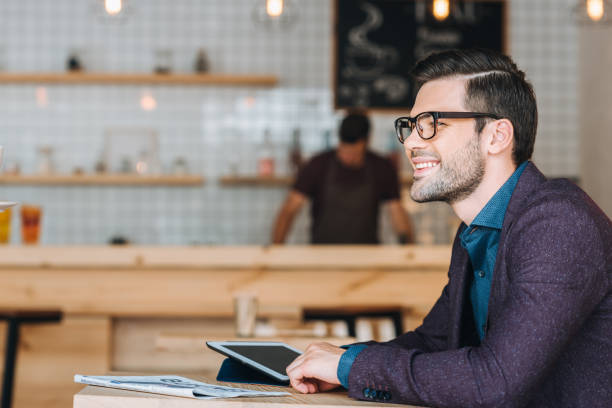 istock smiling businessman in cafe 841228406