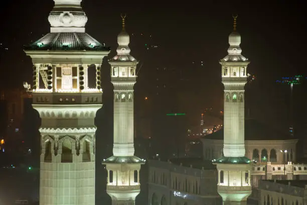 Mecca holy mosque at night with all minarets in light