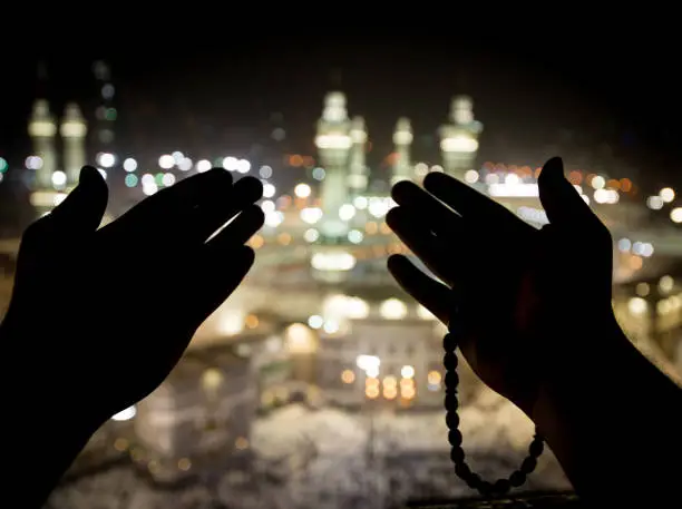 Muslim hands praying in Kaaba