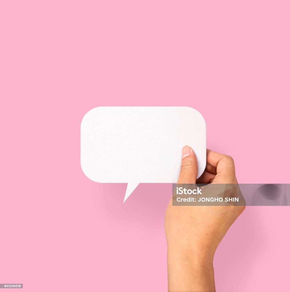 Hand holding an empty speech bubble Human Hand, Paper, Information Medium, Message, Sign Speech Bubble Stock Photo