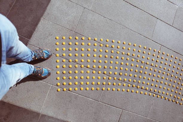 Male feet standing on blind pedestrian walking