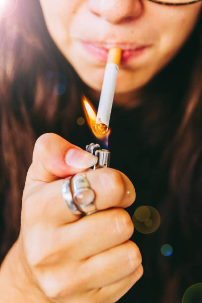 istock Young Adult Woman Lighting Her Cigarette 841238258