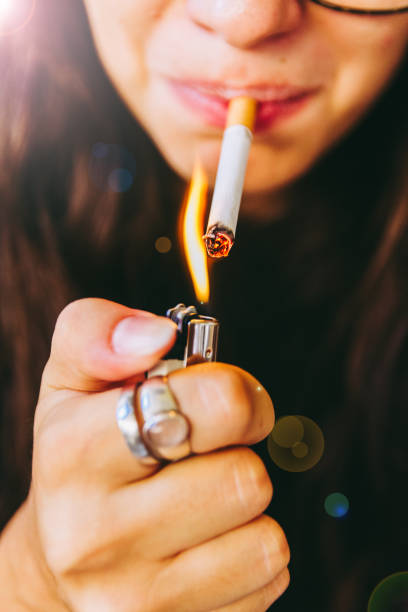 istock Young Adult Woman Lighting Her Cigarette 841241248