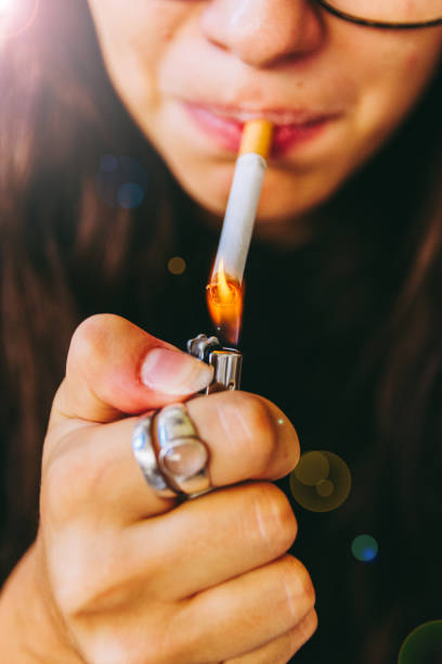 istock Young Adult Woman Lighting Her Cigarette 841241796