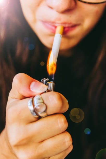 istock Young Adult Woman Lighting Her Cigarette 841244404