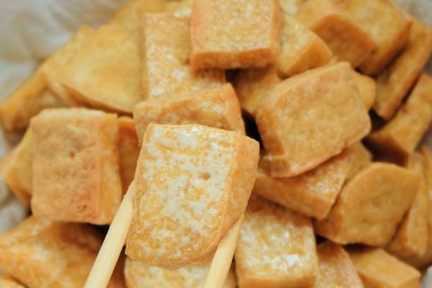 istock Chopsticks Holding Golden Brown Deep Fried Tofu 841244942