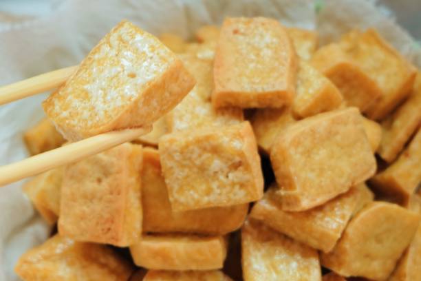 istock Chopsticks Holding Golden Brown Deep Fried Tofu 841244964