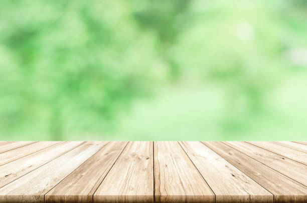 istock Empty wooden table top with blurred green natural abstract background. can be used product display. 841245280
