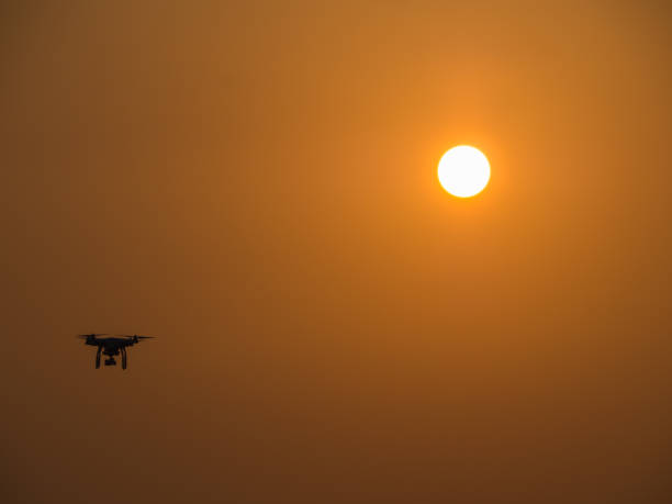 istock Drone Flying in The Sky Behind The Sun 841246686