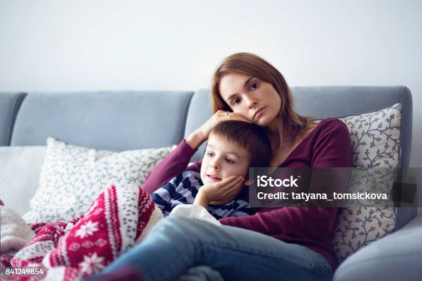 Young Mother Holding Her Little Sick Boy Stock Photo - Download Image Now - Mother, Sadness, Child