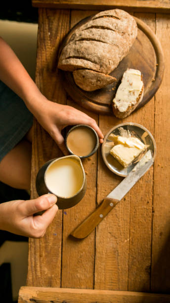istock Top view woman has breakfast adds milk to coffee 841250346