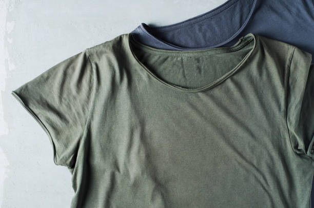 istock Green t-shirt on a grey concrete background. Template for design 841254276