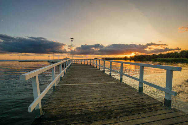 istock Sunset on the lake, wooden, white pier 841271954