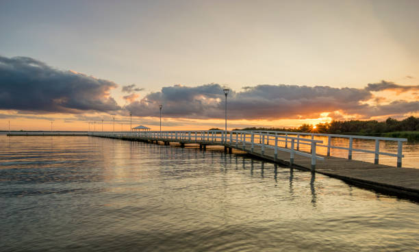 istock Sunset on the lake, wooden, white pier 841272148