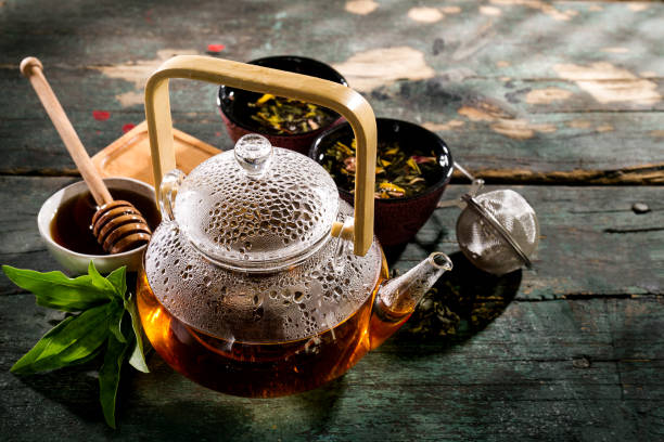 istock Beautiful Tea Ceremony Glass Teapot Honey Mint Cups on Old Rustic Green Table Background Closeup Horizontal 841275404