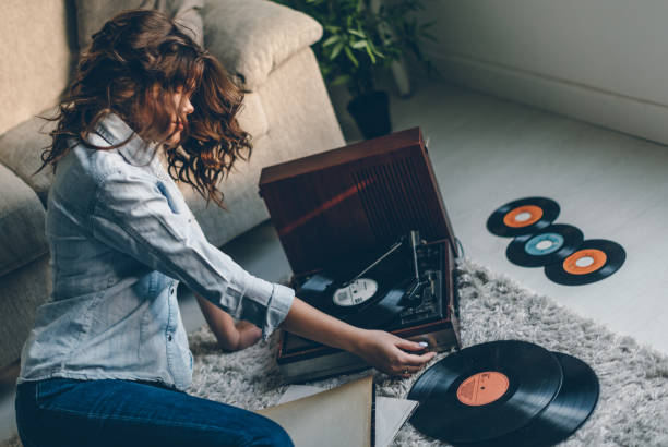 istock Young woman enjoing music from gramophone 841275686