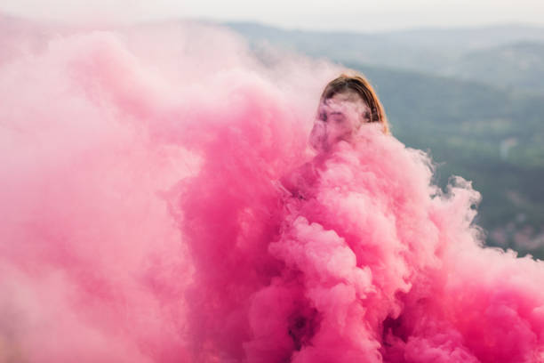 Young girl holding a red smoke torch