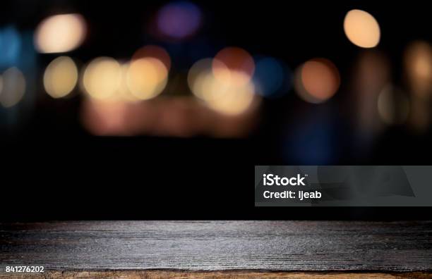 Empty Wooden Table Platform And Bokeh At Night Stock Photo - Download Image Now - Table, Backgrounds, Black Color