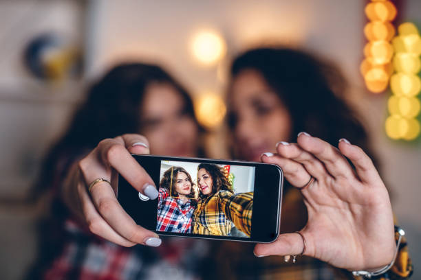 istock Two young girls taking selfies at home 841279362