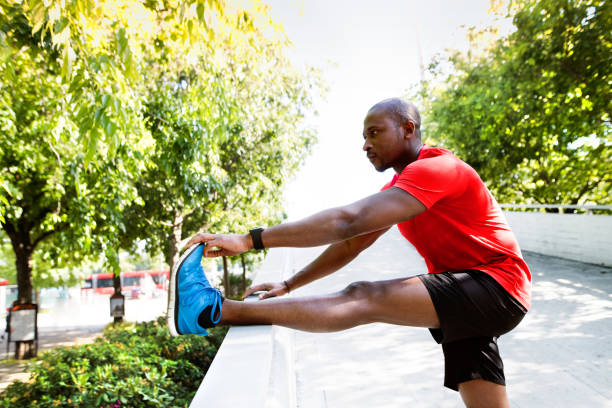istock Young afro-american runner in the city stretching his legs. 841281666