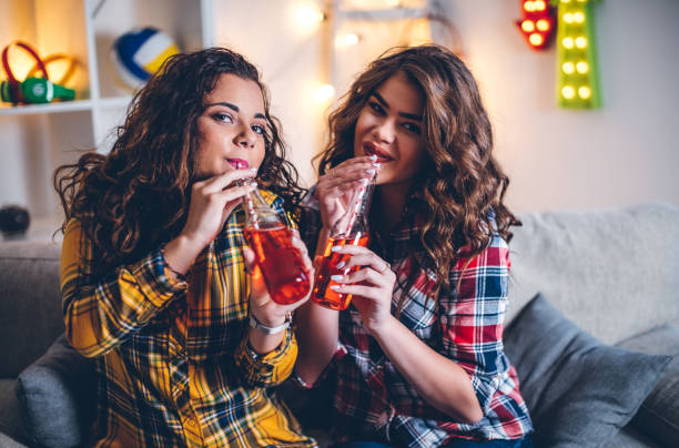 istock Girls smiling while saying cheers with cooldrink 841281916