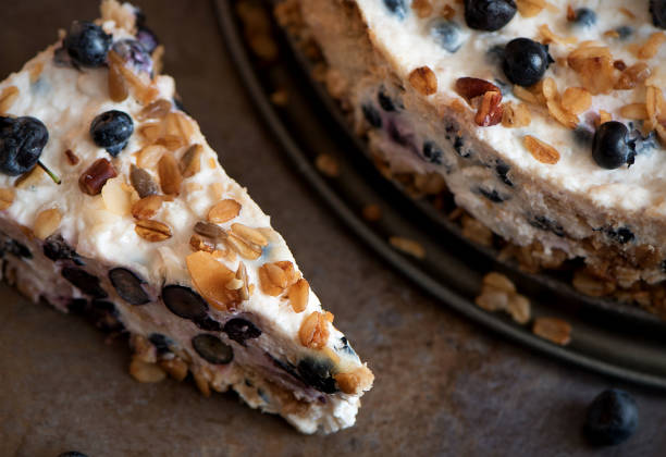 Sour cream cake with granola, biscuits and blueberries