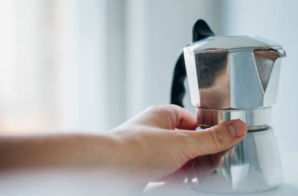 istock Caucasian male hand reaching for a stove pot espresso maker 841282712