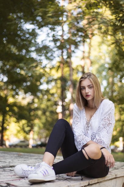 istock Young pretty girl sitting in nature 841282772